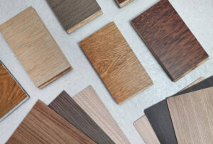 A variety of wood samples are laid out on a table.